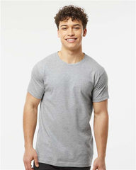 A man wearing a Tultex Unisex Fine Jersey T-Shirt made of 100% ringspun cotton, with double-needle stitching.