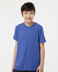 A young boy wearing a Tultex Youth Fine Jersey T-Shirt made of USA cotton with double-needle stitching.