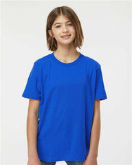 A young girl wearing a Tultex Youth Fine Jersey T-Shirt made of ringspun, USA cotton. The Tultex shirt is expertly crafted with double-needle stitching for added durability.