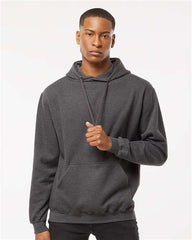 A man wearing a Tultex Unisex Fleece Hoodie Sweatshirt, made of ringspun cotton/polyester material.