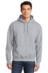 A man wearing a Gildan - DryBlend Pullover Hoodie Sweatshirt 12500 made of a cotton blend fabric with double-needle stitching.