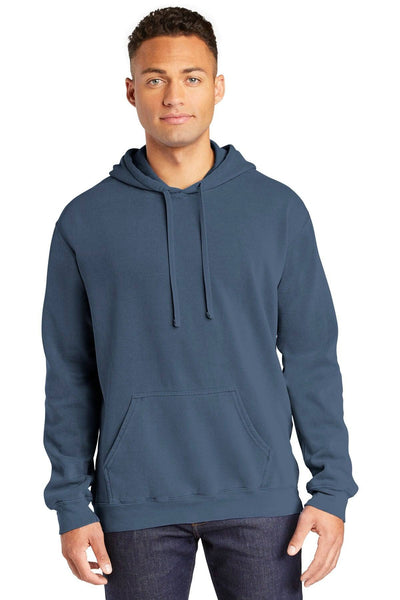 A man in Comfort Colors Ring Spun Hoodie Sweatshirt 1567, dark blue, and jeans stands facing forward against a plain white background.