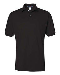 The black JERZEES Jerzees Midweight Polo Cotton Poly Blend SpotShield 50/50 features a collar, short sleeves, and two buttons at the neck.
