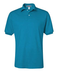A solid teal JERZEES Jerzees Midweight Polo Cotton Poly Blend SpotShield 50/50 shirt with a collar and buttoned placket, featuring SpotShield technology.