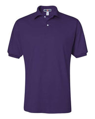 The JERZEES Midweight Polo Cotton Poly Blend SpotShield 50/50 is a plain purple, short-sleeved polo shirt with a collar and two buttons, featuring SpotShield technology for stain resistance.