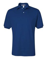 The JERZEES Midweight Polo Cotton Poly Blend SpotShield 50/50 is a plain, short-sleeved navy blue polo shirt with a collar and three buttons, featuring SpotShield technology for easy maintenance.
