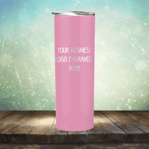 Promotional Kodiak Coolers pink stainless steel tumbler with customizable logo space displayed on a wooden surface against a bokeh backdrop.