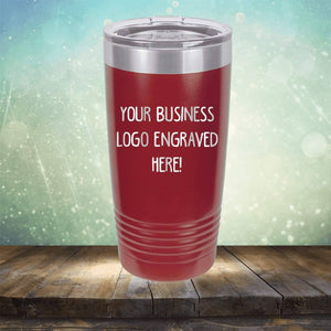 Promotional Kodiak Coolers insulated tumbler with an engraved logo space on a wooden surface against a bokeh background.