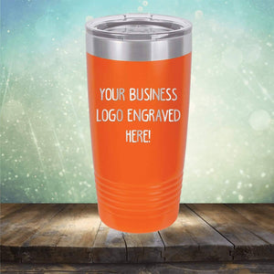 An orange insulated tumbler, Custom Logo 20 oz Tumblers from Kodiak Coolers, custom printed with a logo placeholder text for a promotional gift, on a wooden surface against a bokeh background.