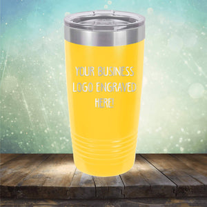 Yellow insulated Custom Logo 20 oz Tumbler by Kodiak Coolers, displayed on a wooden surface against a bokeh background.