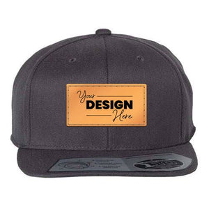 A black Flexfit 110 Flat Bill Snapback Hat with an orange patch on it features snapback closure.