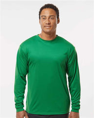A man wearing a C2 Sport Performance Long Sleeve T-Shirt made of moisture-wicking fabric.