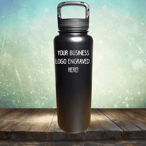 Stainless steel tumblers with customizable logo space displayed on a wooden surface with a bokeh background from Kodiak Coolers' SECOND CHANCE SALE - Custom Engraved Drinkware - SPECIAL 72 HOUR SALE PRICING - Single Side Engraving Included in Price.