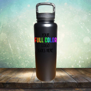 A black Kodiak Coolers Custom UV Printed Drinkware - ONE TIME SPECIAL OFFER with a handle on top is placed on a wooden surface. The text on the bottle reads "YOUR FULL COLOR LOGO GOES HERE." Imagine the sleek design complementing your collection of tumblers in a charming coffee corner, all set against a light, sparkling bokeh background.