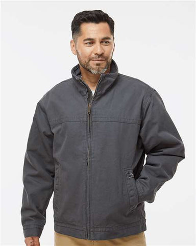 A man with short dark hair and a beard, wearing a DRI DUCK Maverick Boulder Cloth Jacket with Blanket Lining, stands against a plain white background.
