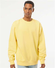 A man wearing a yellow Independent Trading Co. Midweight Pigment-Dyed Crewneck Sweatshirt and jeans, creating a strong impression.