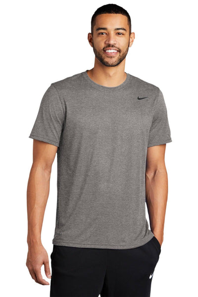 Man in a Nike Legend T-Shirt 727982, gray with Dri-FIT technology, paired with black pants.