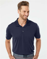 A man sporting an Adidas Lightweight Performance Polo made from 100% recycled polyester.