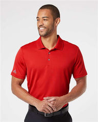 A man wearing an Adidas Lightweight Performance Polo 100% Recycled Polyester.