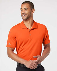 A man wearing an Adidas Lightweight Performance Polo 100% Recycled Polyester made from recycled polyester.