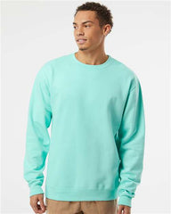 A man wearing an Independent Trading Co. Midweight 100% Cotton Crewneck Sweatshirt SS3000 made of a cotton/polyester blend fleece.