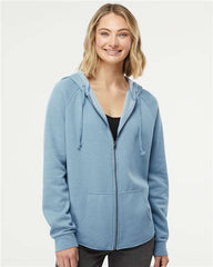 A woman wearing a customized Independent Trading Co. Women's California Wave Wash Full-Zip Hoodie Sweatshirt with a zippered hood.
