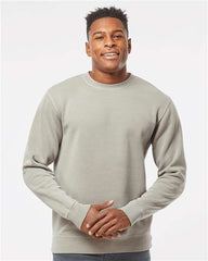 A man sporting a customized Independent Trading Co. Midweight Pigment-Dyed Crewneck Sweatshirt and jeans, creating a strong impression with his stylish branding.