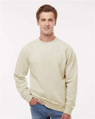 A man wearing a beige Independent Trading Co. Midweight Pigment-Dyed Crewneck Sweatshirt and jeans.