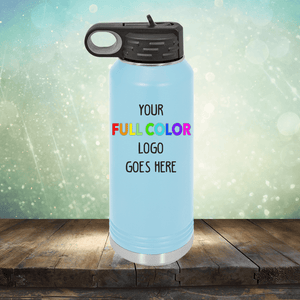 A light blue water bottle stands on a wooden surface against a sparkly background, next to colorful coffee mugs. The text "Custom UV Printed Drinkware - ONE TIME SPECIAL OFFER" by Kodiak Coolers is printed on it in various colors.