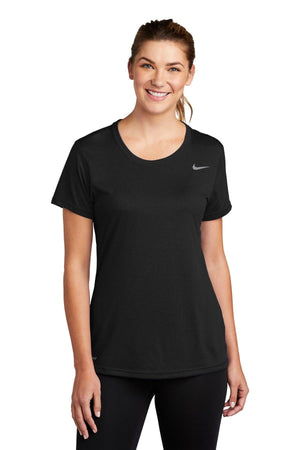 Woman in a Nike Ladies Legend T-Shirt CU7599 with Dri-FIT technology and leggings, smiling at the camera.