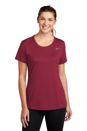 Woman in a maroon Nike Ladies Legend T-Shirt CU7599 with Dri-FIT technology, smiling at the camera.