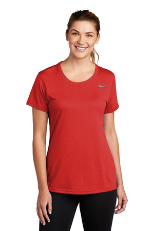 Woman wearing a red Nike Ladies Legend T-Shirt CU7599, smiling at the camera.