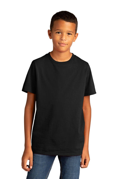 A young boy showcases the District Youth Re-Tee T-Shirt DT8000Y in plain black, made from recycled fabric, along with blue jeans against a white background.