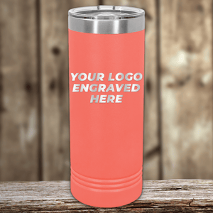 A coral Kodiak Coolers travel tumbler with a stainless steel lid sits on a wooden surface, featuring your custom laser-engraved logo. Includes one-side engraving with no setup fee—perfect for New Years Sale promotional gifts or personalized collections.