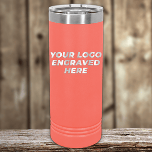 A coral Kodiak Coolers tumbler with a stainless steel lid rests on wood, engraved with "YOUR LOGO ENGRAVED HERE"—an ideal Realtor closing gift, personalized with your custom company logo for standout client appreciation.