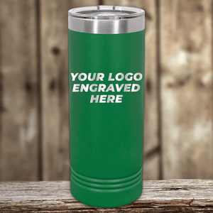 A green Kodiak Coolers tumbler with a stainless steel lid sits on wood, featuring "YOUR LOGO ENGRAVED HERE." Perfect as a Realtor closing gift—customize with your company logo for clients using this stylish drinkware.