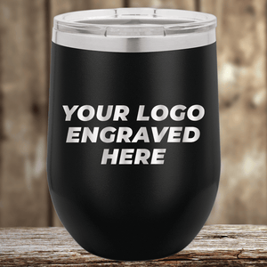 Kodiak Coolers' Realtor Closing Gifts for Clients features your custom company logo engraved on drinkware, perfect as branded promotional items. A black insulated tumbler sits on a wooden surface with a blurred wood background.