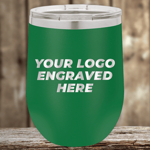 The Kodiak Coolers Realtor Closing Gifts for Clients features your custom company logo engraved on green insulated drinkware with a silver lid—perfect for promotional use—shown on a wooden surface against a blurred wood background.