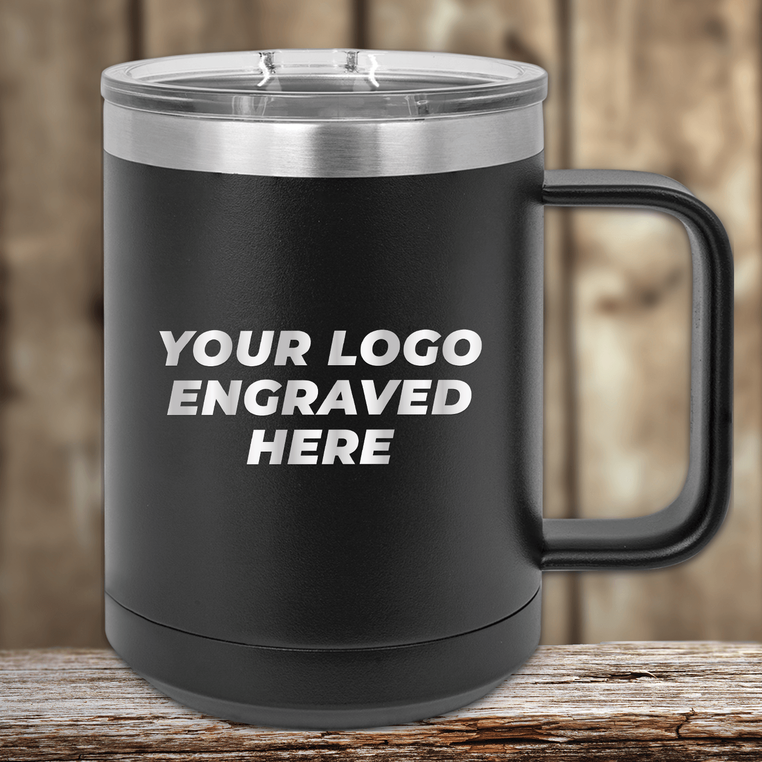 A black 15 oz Kodiak Coolers insulated mug with a silver lid sits elegantly on wood, featuring "YOUR LOGO ENGRAVED HERE" in white. Ideal for custom mugs or promotional gifts, each purchase includes a logo engraving and setup fee.
