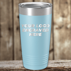 A light blue metal tumbler by Kodiak Coolers with your custom company logo engraved, showcased on a wooden surface—ideal as a unique Realtor closing gift for clients.