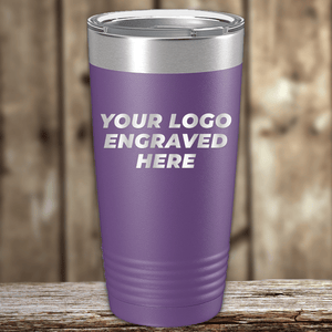 A purple Kodiak Coolers tumbler with a silver lid and your custom company logo engraved—ideal as a Realtor closing gift for clients—sits on a wooden surface against a blurred wooden background.
