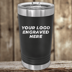 A black stainless steel tumbler with a clear lid by Kodiak Coolers, engraved with your custom company logo—ideal as Realtor closing gifts for clients and perfect promotional drinkware for your brand.