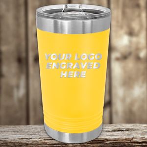 A yellow Kodiak Coolers tumbler with metal lid and trim, engraved with your custom company logo—ideal as a Realtor closing gift—rests on a wooden surface against a blurred wood background.
