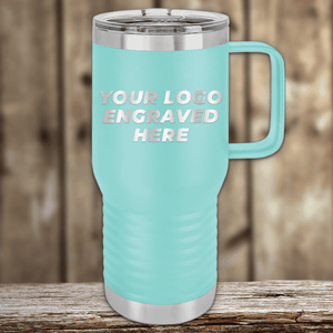 A light blue travel mug with a handle and stainless steel accents by Kodiak Coolers, featuring your custom company logo engraved—ideal as Realtor closing gifts for clients or unique promotional mugs—displayed on a wooden background.