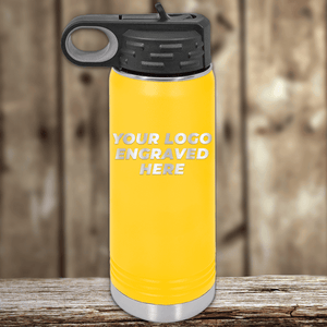 A Kodiak Coolers water bottle with your custom company logo engraved on its front sits on a wooden surface—ideal as a Realtor Closing Gift for clients seeking stylish, personalized drinkware.