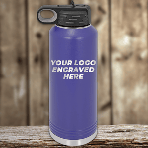 A blue Kodiak Coolers water bottle with a black lid features "YOUR LOGO ENGRAVED HERE"—the perfect Realtor closing gift for clients. Showcase your brand alongside other promotional drinkware or custom logo mugs.