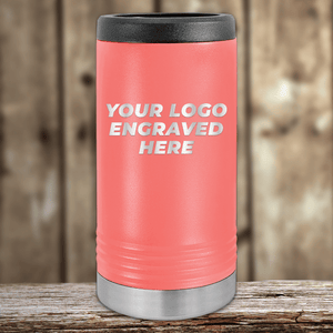 A pink Kodiak Coolers tumbler with a silver base rests on wood, engraved with "YOUR LOGO ENGRAVED HERE." Ideal as a Realtor closing gift for clients—customize it with your company logo for personalized drinkware. Wood paneling background.