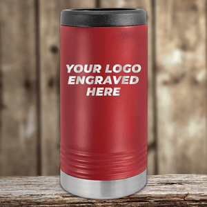 Red insulated tumbler with black lid and silver base, featuring "Your Custom Company Logo Engraved" by Kodiak Coolers—Realtor Closing Gifts for Clients—displayed on a wooden surface with a wood panel background.