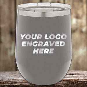 Stainless steel insulated Custom Wine Cups 12 oz with your Logo or Design Engraved by Kodiak Coolers displayed on a wooden surface.