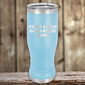Promotional Custom Pilsner Glasses 14 oz with your Logo or Design Engraved - Low 6 Piece Order Minimal Sample Volume displayed on a wooden surface. Made by Kodiak Coolers.